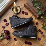 Acherontia High Tops black sole flat lay with candle and dried roses