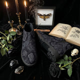 Acherontia Chelsea Boots — altar flat lay with deaths-head moth shadowbox, candles, black roses, crystals