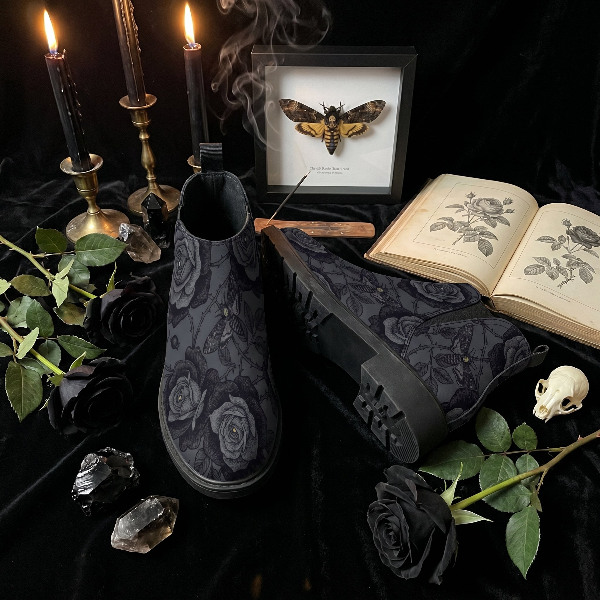 Acherontia Chelsea Boots — altar flat lay with deaths-head moth shadowbox, candles, black roses, crystals