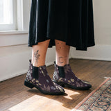Achillea Chelsea Boots worn with black skirt indoor lifestyle