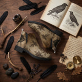 Corvus Chelsea Boots - vintage natural history flat lay with raven feathers ink quill antler