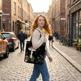 Skathea Digitalis tote bag on model walking cobblestone street