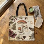 Skatheia Materia Medica tote bag — flat product shot on wood floor