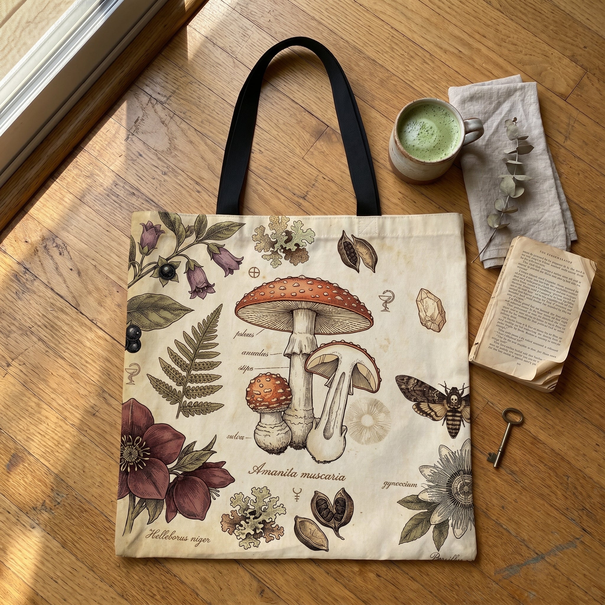 Skatheia Materia Medica tote bag — flat product shot on wood floor
