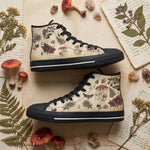 Materia Medica High Tops — vintage apothecary encyclopedia plates on aged parchment with passionflowers, amanita mushrooms, hellebores, death's-head moth, and sepia Latin annotations — flat lay with candle and dried roses