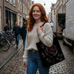Skathea Thornveil Rose tote bag on model walking cobblestone street